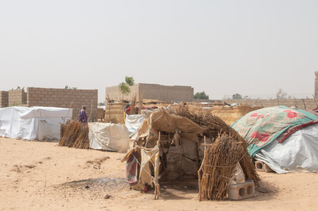 An encampment comprised of several makeshift homes and tents.